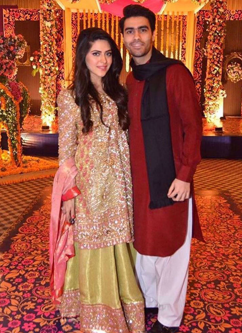 Maham sparkling in a custom made kiwi green and candy pink Farah Talib Aziz ensemble