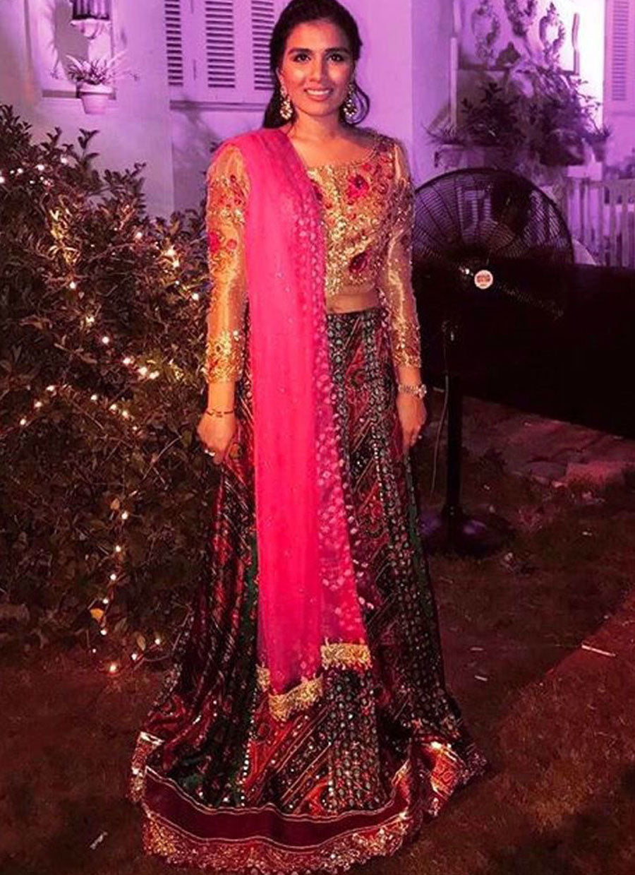 Shumaila Assad looking uber festive in a shimmering bronze-gold Farah Talib Aziz choli and emerald lengha