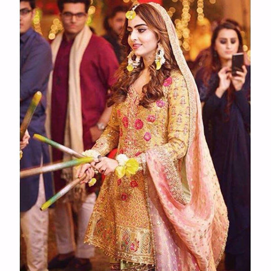 Sara, glowing in a saffron yellow kalidaar paired with a mint gharara