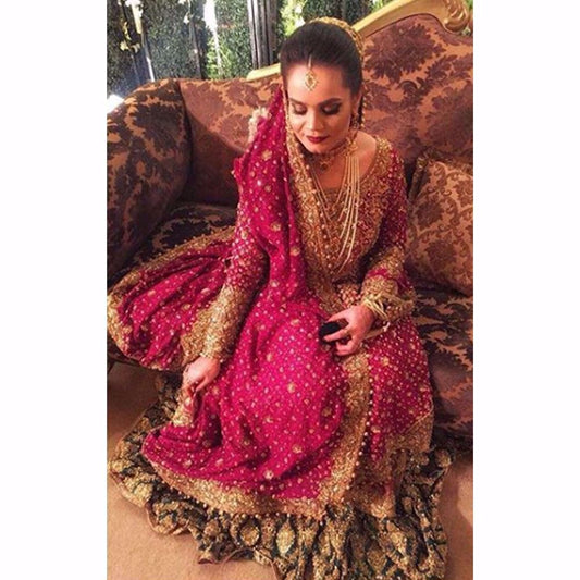 Sarah, traditionally regal in an anaar red and emerald green Farah Talib Aziz bridal