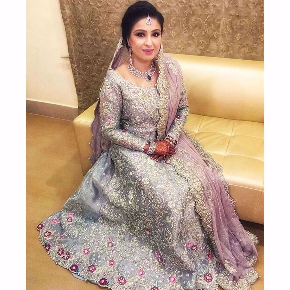 Bushra in an ice blue Farah Talib Aziz bridal featuring a filigree of silver and Swarovski embellishments