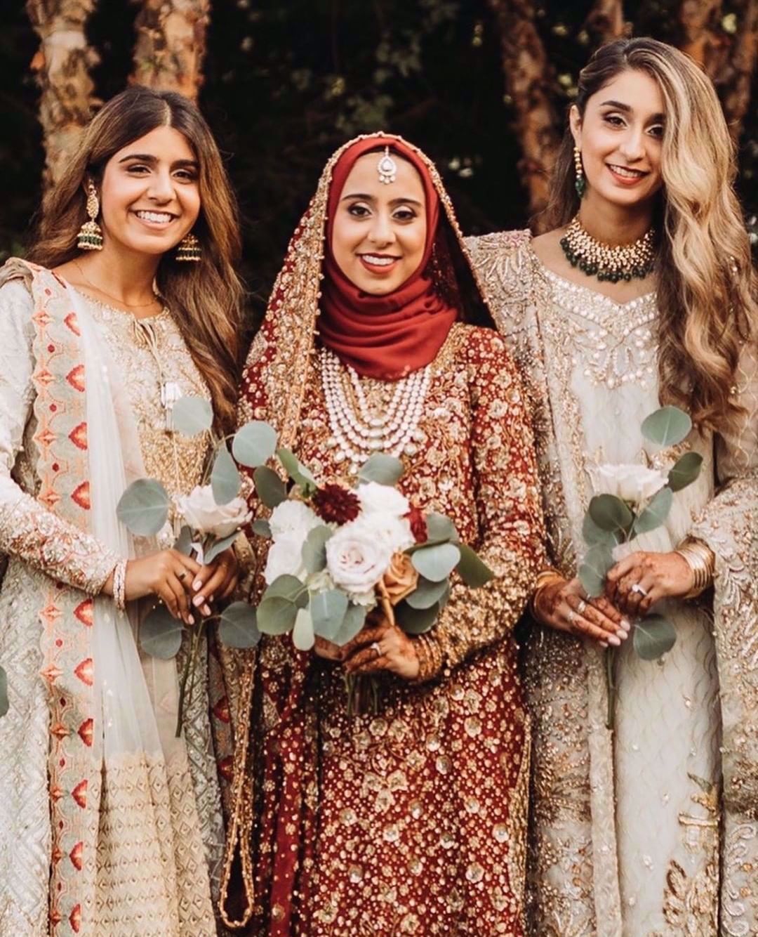 Marriyah Simjee, resplendent at her wedding in traditional shades of reds featuring intricate embellishments in gorgeous, glistening golds