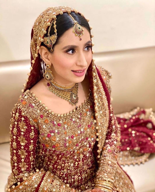 Sana Humayun wears a traditional #FarahTalibAziz ensemble in scarlet red with gold embellishments masterfully hand-embroidered onto the finest of fabrics to create a stunning heirloom bridal