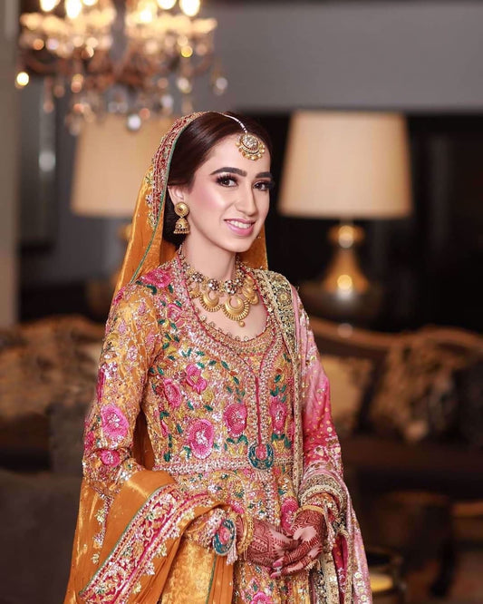 Jannat at her mehdni wearing a traditonal #FarahTalibAziz kalidaar in riot of colours and fine fabrics accentuated with gold embellishments and threadwork in shades of bougainvillea pink