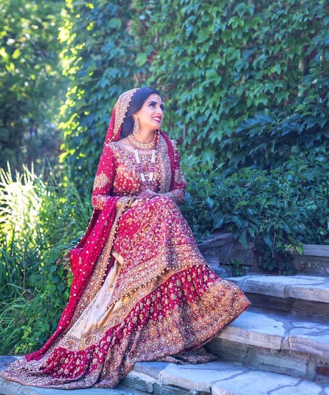 Farah Talib Aziz gives us a masterclass on how to carry the iconic red bridal. Featured here is a traditional scarlett red ensemble with gold embellishments